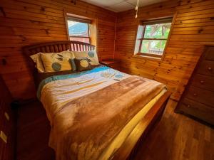 a bedroom with a bed in a log cabin at Riverview Ridge in Piney Creek