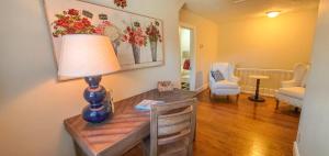 a room with a table with a lamp on it at Walnut Hill in West Jefferson
