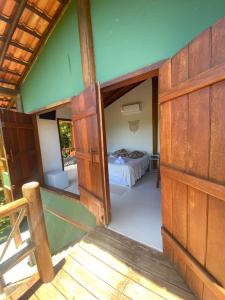 an open door of a room with a bed at Casa Lua Cheia in Praia do Espelho