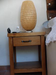 a wooden table with a vase on top of it at Kavousi Cottages - O Stavlos in Kavoúsion