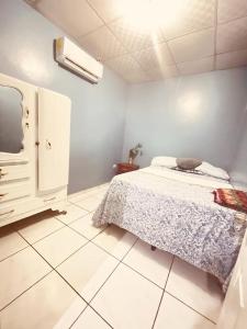 a bedroom with a bed and a tv in it at Cuco Beach Paradise Villa in Chirilagua