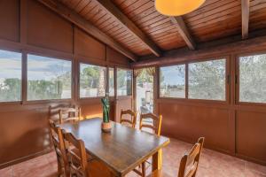 a dining room with a table and some windows at Countryside Treasure by Fidalsa in Lorquí