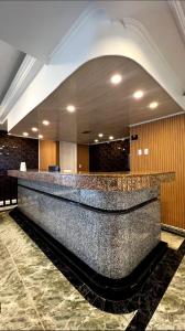 a lobby with a granite counter top in a building at Holiday Sai Hotel in San Andrés