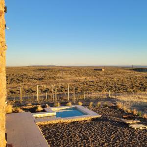 a swimming pool in the middle of a desert at Casona Islas Blancas in Camarones