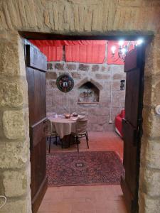a dining room with a table and a fireplace at Alloggio Turistico "L'Incontro" 6 in Viterbo
