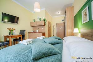 Łóżko lub łóżka w pokoju w obiekcie Baltic Apartments - Apartamenty Korony Piastów