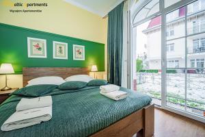 Łóżko lub łóżka w pokoju w obiekcie Baltic Apartments - Apartamenty Korony Piastów