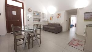 a dining room and living room with a table and chairs at Casa vacanze G&G in Brindisi