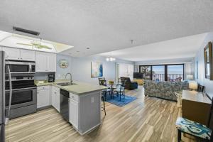 a kitchen and living room with a view of the ocean at 201 Sandy Shores Condos in St. Pete Beach