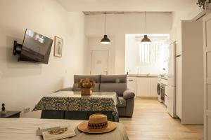 a small living room with a table and a couch at Apartamentos RG Hospital Valme in Seville