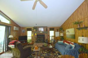 a living room with a blue couch and a fireplace at A Zen Mountain Retreat - Nirvana Awaits in Baxter