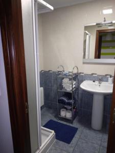 ein Bad mit einem Waschbecken und einem Spiegel in der Unterkunft A Las faldas del Tecla in A Guarda