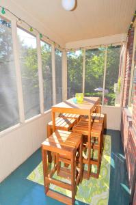 a screened in porch with a table and chairs at Aunt Bea's Bungalow - Pet Friendly - Hot Tub - Screen Porch - Wifi - Fenced Yard - King Bed - Town in Berkeley Springs +8 photos