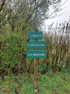 um sinal com quatro sinais num poste de madeira em Le Petit Refuge 