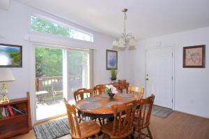 a dining room with a table and chairs at Cacapon Connected - Wifi, Fire Pit, Game Room, King Bed, Deck, Grill, Fireplace, Pet Friendly, Garage for mountain bike storage in Morton Grove
