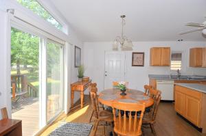 a kitchen and dining room with a table and chairs at Cacapon Connected - Wifi, Fire Pit, Game Room, King Bed, Deck, Grill, Fireplace, Pet Friendly, Garage for mountain bike storage in Morton Grove +30 photos