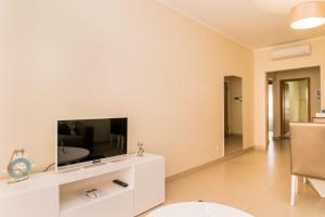 a living room with a television on a white entertainment center at NEW !! Two Bedroom Cabanas Tavira - Banda Musical ORANGE in Tavira