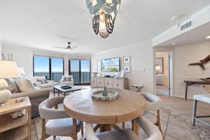 a living room with a table and chairs at Phoenix X 1203 in Perdido Key