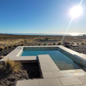 a swimming pool in the middle of the desert at Casona Islas Blancas in Camarones