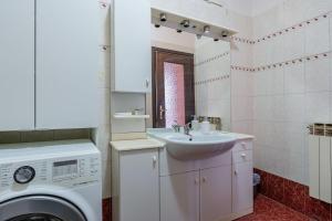 a bathroom with a sink and a washing machine at Apartment in Via Cremona - Brescia City - by Host4U in Brescia