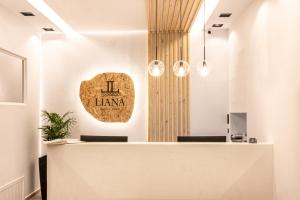 a lobby with ahi hawaina sign on the wall at Liana Beach Hotel & Spa in Agios Prokopios