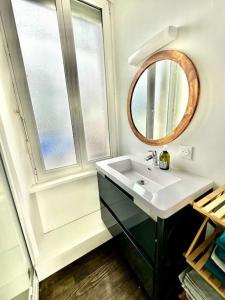 a bathroom with a sink and a mirror at La dolce Vita/maison/5km plages in Saint-Brieuc +29 photos