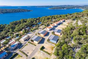 an aerial view of a row of houses and the water at Kasthouse Luxury Nature Getaway in Mali Lošinj