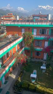 an overhead view of a building with benches in a yard at New Pokhara Lodge - Lakeside, Pokhara Nepal in Pokhara