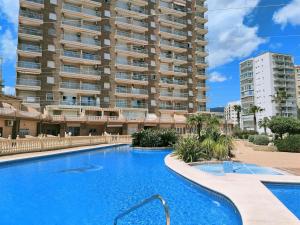 um grande edifício de apartamentos com uma grande piscina em Precioso estudio primera linea Fossa-Puerto Calpe em Calpe