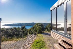 a house with a view of the water at Kasthouse Luxury Nature Getaway in Mali Lošinj