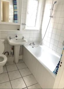 a bathroom with a tub and a sink and a toilet at Ac lounge 115 1-Bed Apartment in Rochford in Rochford