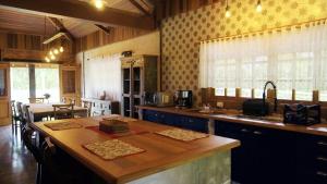 a kitchen with a wooden counter top in a room at Rancho Curica in Campos do Jordão +21 photos