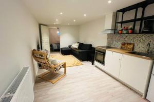 a kitchen and a living room with a couch at Newly built amazing apartment in Järfälla