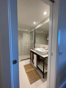 uma casa de banho com um lavatório e um chuveiro em Magnólia 75 em Leça da Palmeira