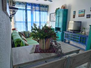 a living room with a table with a vase on it at Vistas al Mar Mediterraneo in Melicena +33 photos