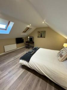 a bedroom with a large bed in a attic at Beautiful two bed home in Marsh in Lindley