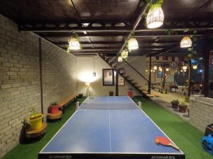 a ping pong table in the middle of a room at The Royal Orchard Kasol in Kasol