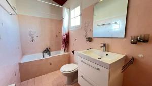 a bathroom with a sink and a toilet and a mirror at maison de vacances au calme et proche de la plage in La Couarde-sur-Mer