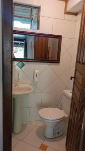 a bathroom with a toilet and a sink at Pousada Sobre as Ondas - ILHA DO MEL - PR in Ilha do Mel