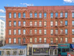 a large red brick building with a fire escape at 1BR Apt Walk to Central Park and Columbia University in New York