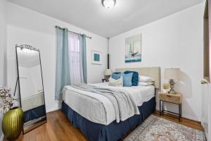 a bedroom with a large bed with blue pillows at 1BR Apt Walk to Central Park and Columbia University in New York