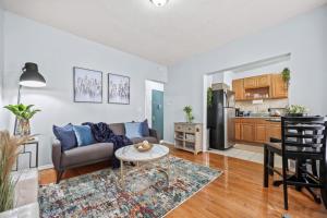 a living room with a couch and a table at 1BR Apt Walk to Central Park and Columbia University in New York