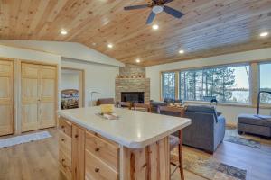 a kitchen and living room with a fireplace at Hines Vacation Rental with Grill Walk to Lake! 