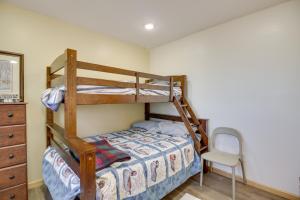 a bedroom with two bunk beds and a chair at Hines Vacation Rental with Grill Walk to Lake! 