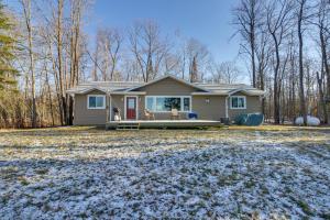 a small house in the woods with snow on the ground at Hines Vacation Rental with Grill Walk to Lake! 