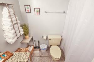 a bathroom with a toilet and a shower at stylish luxe condo! in Fort Walton Beach
