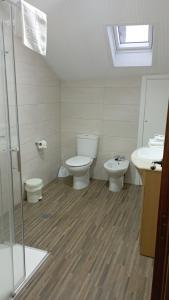 a bathroom with a toilet and a sink at Casa Torre Vella in Bueu +20 photos