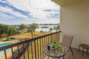 a balcony with a table and a view of the water at stylish luxe condo! in Fort Walton Beach