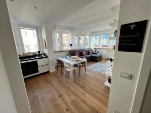 a kitchen and living room with a table and chairs at Conte Cavour in Udine