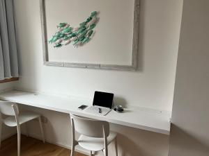 a white desk with a laptop and two chairs at Conte Cavour in Udine +8 photos